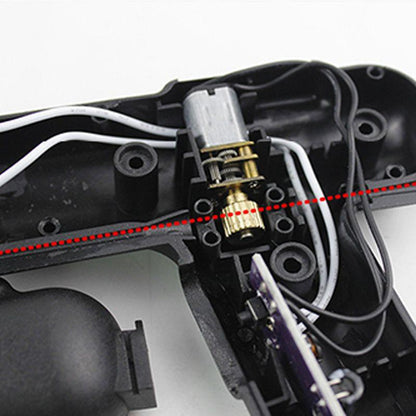 Close-up of electronic wiring and motor gears inside a black plastic auto tool housing